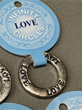 NWT eleven infinity circle imprinted with love. Layered in sterling silver.